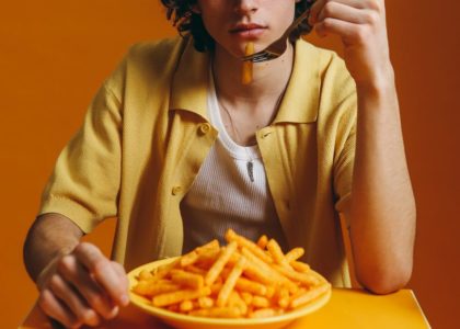 young man eating fries
