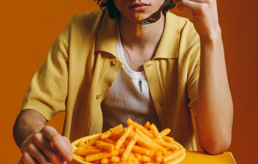 young man eating fries